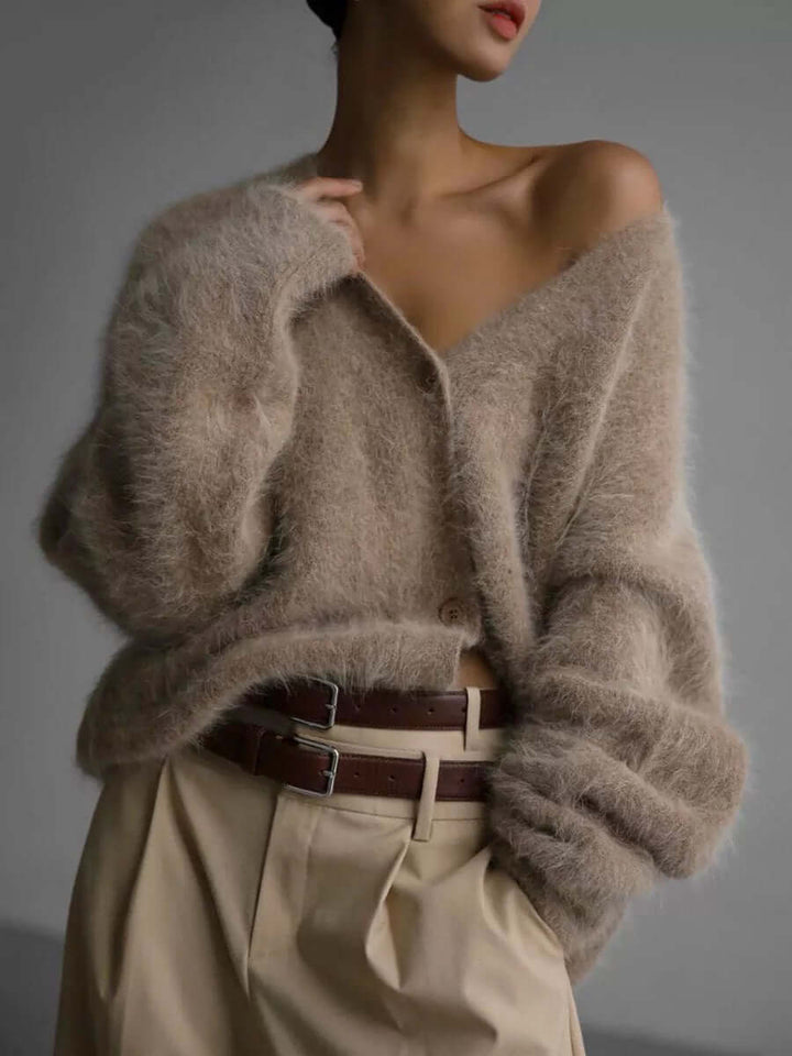 Close-up of soft knit fluffy texture on a women's cozy cardigan sweater, comfortable winter fashion.