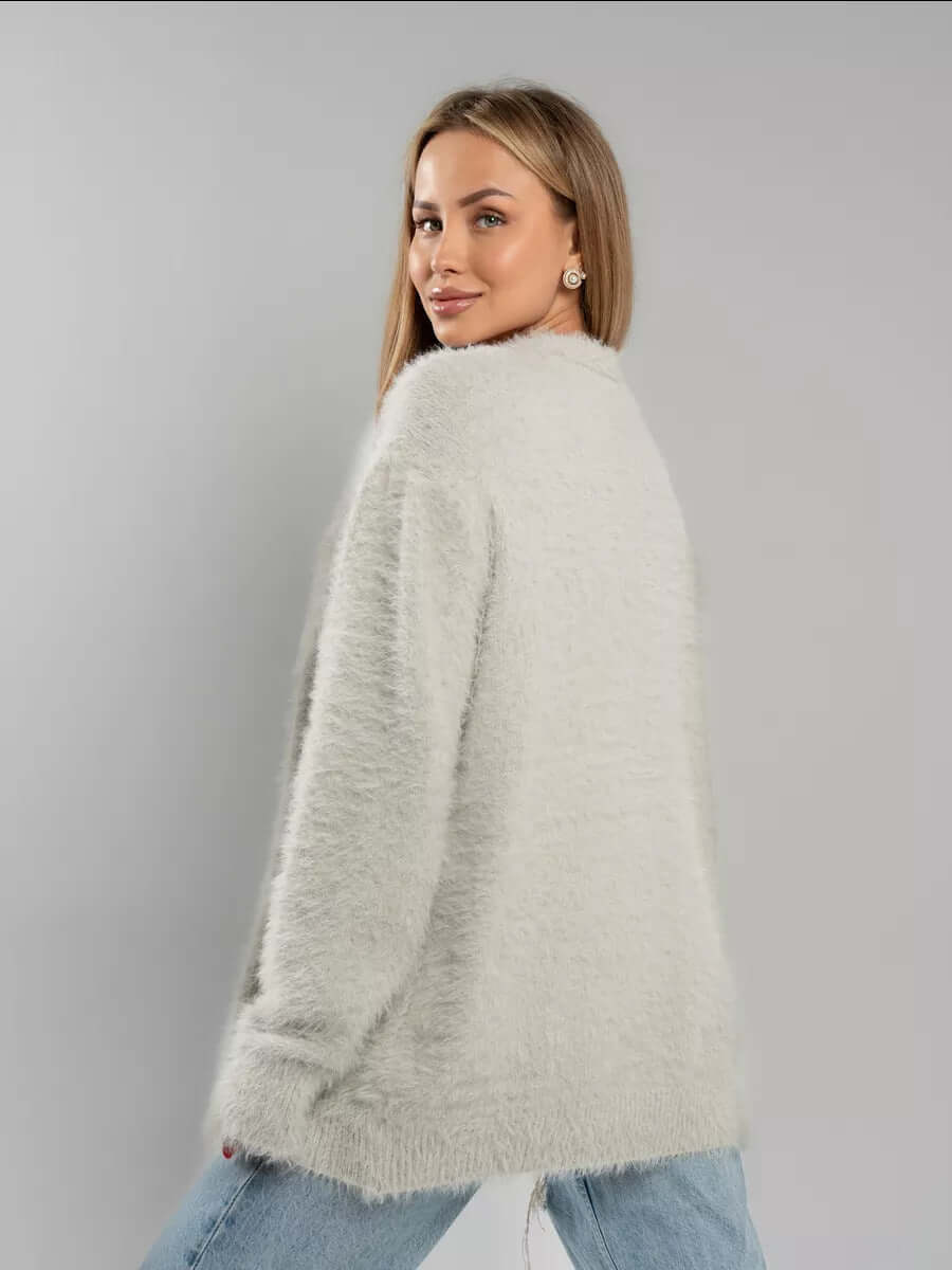 Woman styling a warm fluffy knit cardigan sweater, ideal for winter layering with open front design.