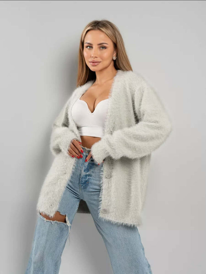Side view of a women's cozy fluffy knit cardigan sweater, long sleeve open front for comfortable wear.