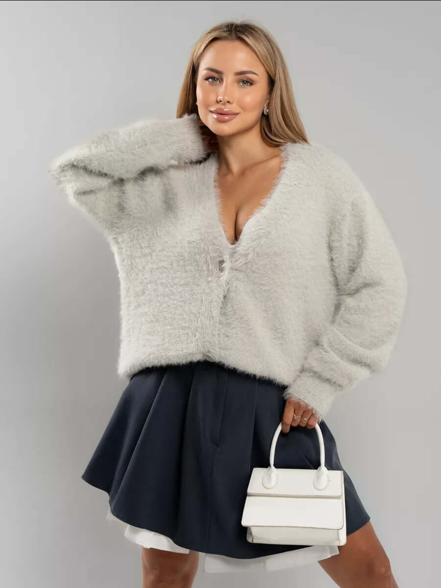 Detail of soft knit cuff on a women's fluffy cardigan sweater, cozy and warm for winter fashion.