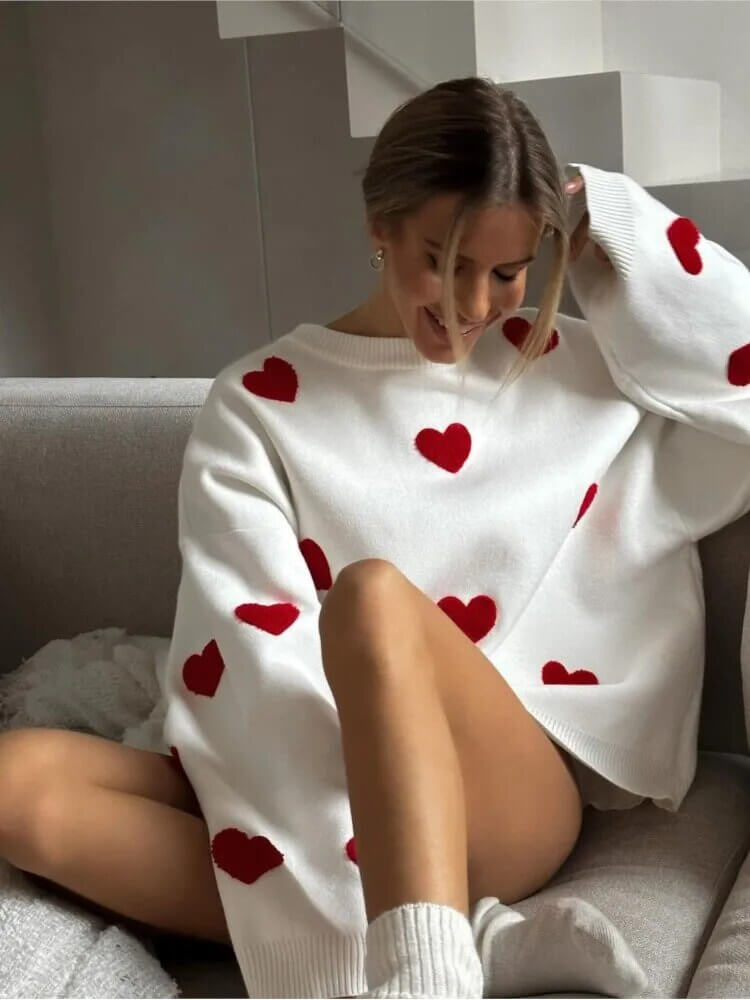 All-over heart print on a cozy women's loose fit sweater, an oversized long sleeve top for casual comfort.
