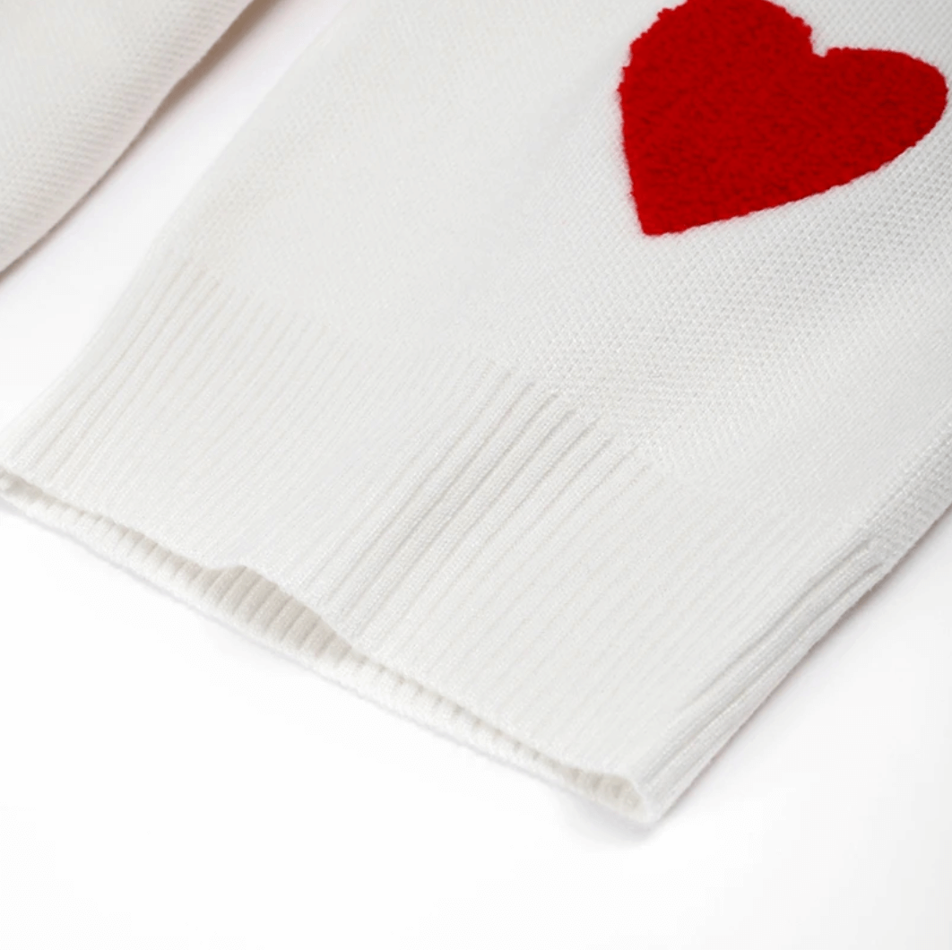 Oversized women's cozy sweater with delicate heart print, offering a relaxed and comfortable casual style.
