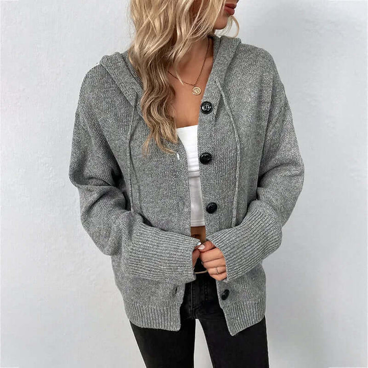 Trendy women's hooded knitted sweater, offering cozy style for everyday apparel.