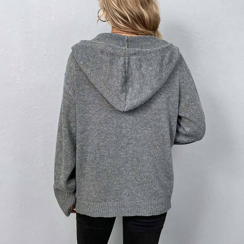 Relaxed fit women's hooded knitted cardigan, essential for cozy winter comfort.