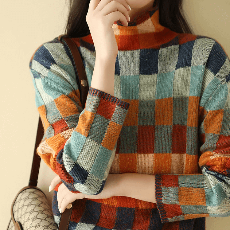 Close-up of soft, cozy knit fabric on a women's high collar winter sweater. Warm, textured pullover.