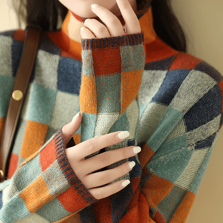 Front view of a women's stylish cozy knit high collar jumper. Comfortable long sleeve pullover sweater for winter.