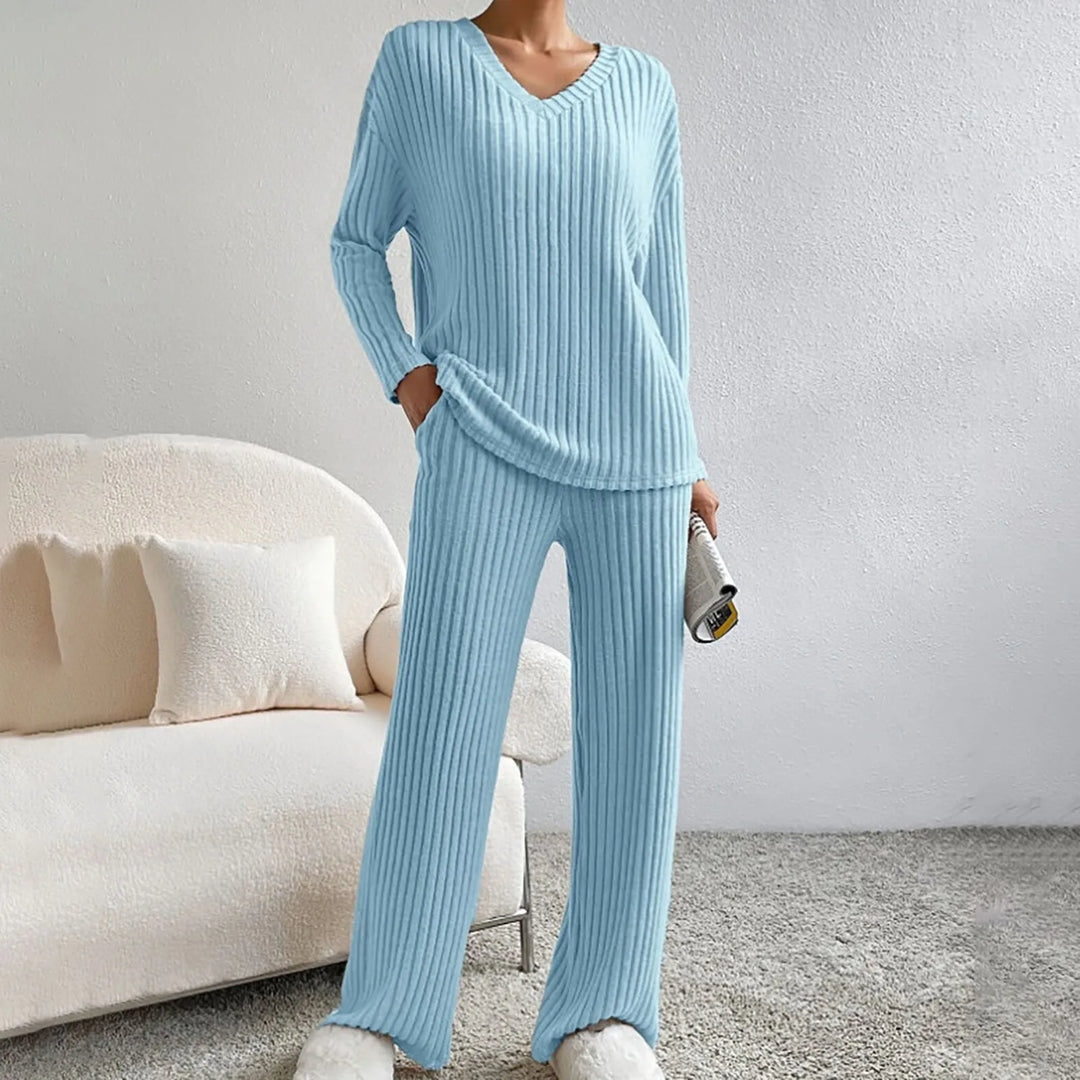 Soft gray women's knitted lounge set, featuring a cozy top and matching pants. Perfect comfort wear.
