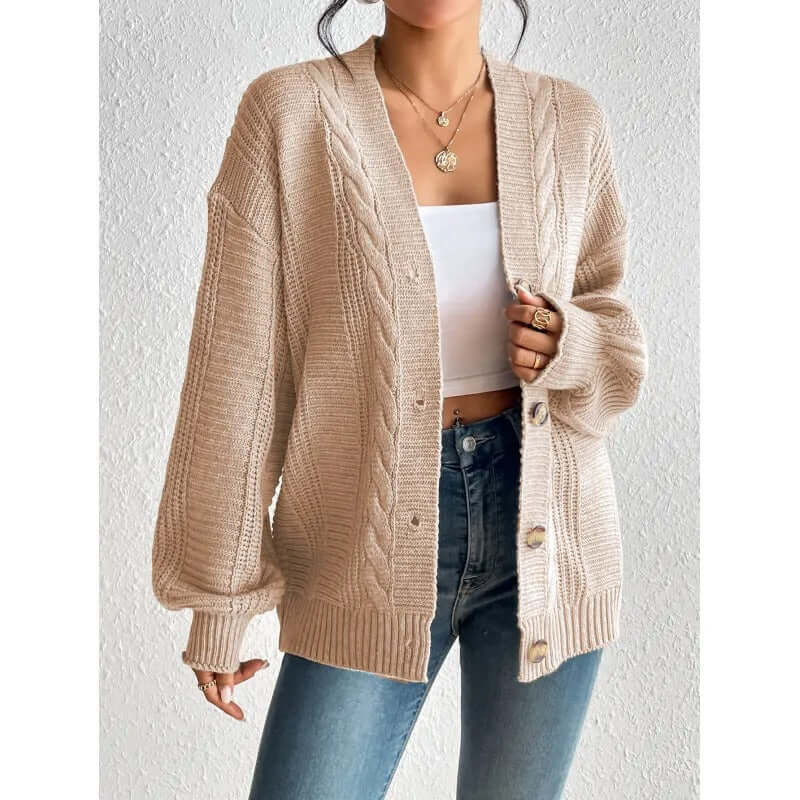 Stylish woman wearing a cozy knitted cardigan sweater, showcasing effortless fall/winter fashion.