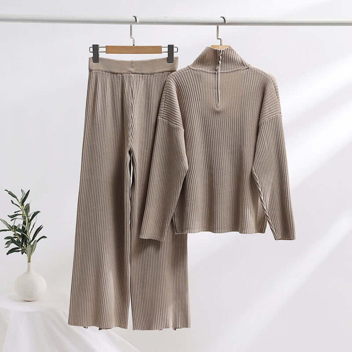 Women's cozy knitted loungewear set in beige, featuring a comfortable knit sweater and stylish wide-leg pants for fall/winter.