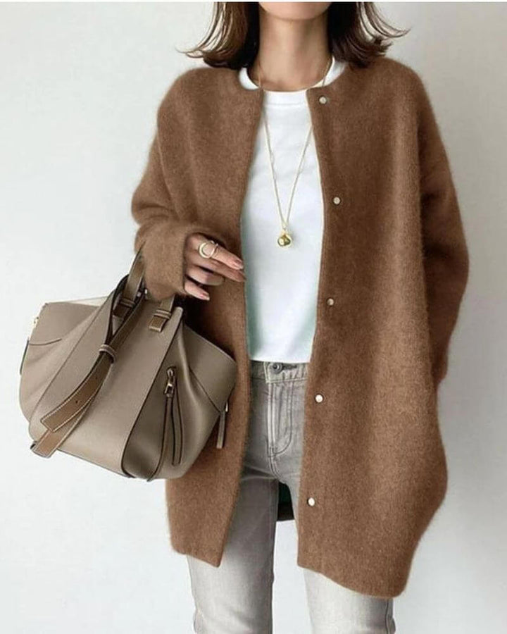 Close-up of a women's soft knitted cardigan, showcasing the cozy yarn texture and elegant open-front style.