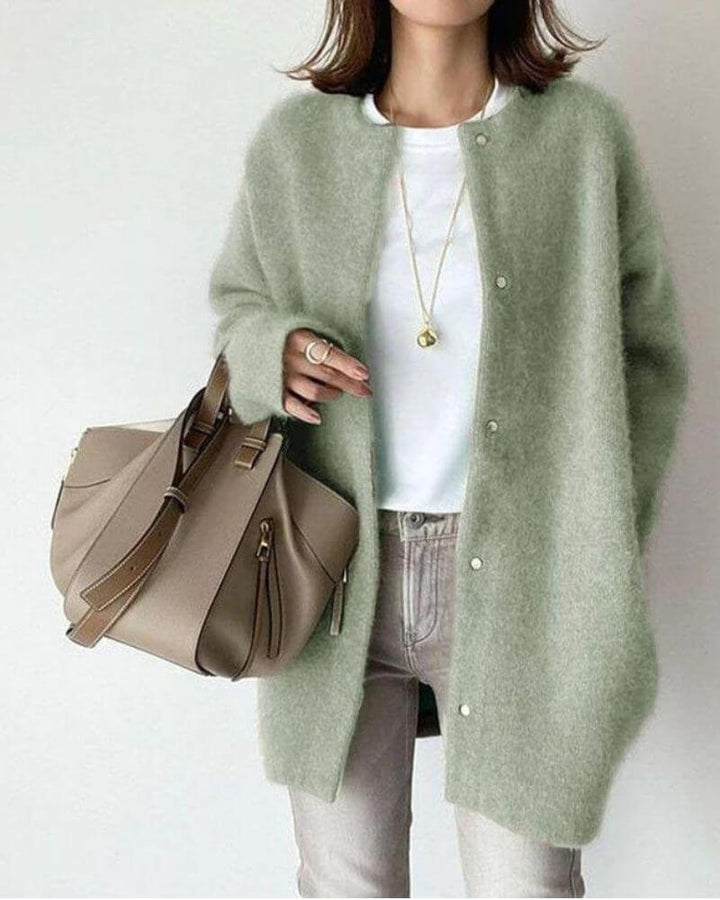 Woman wearing a stylish long-sleeve knitted cardigan, an essential cozy open-front sweater for everyday comfort.