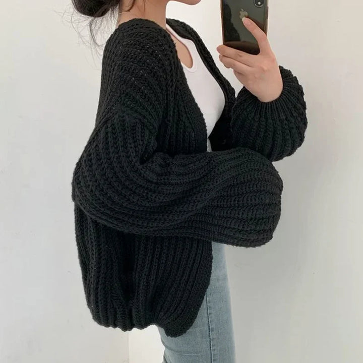 Cozy women's oversized knitwear cardigan with stylish open front & lantern sleeves. Perfect for winter warmth.
