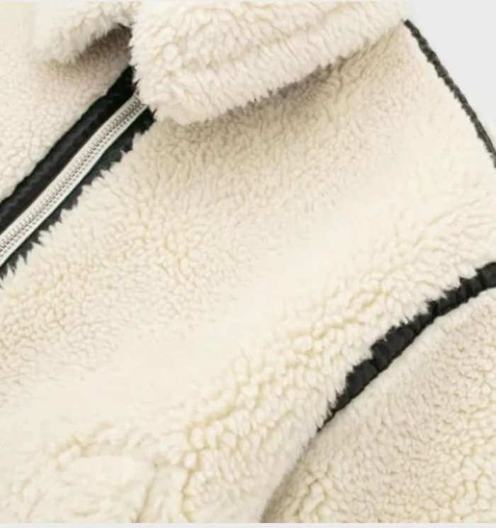 Close-up of a women's soft beige oversized fleece zip jacket, highlighting its cozy texture and warmth.