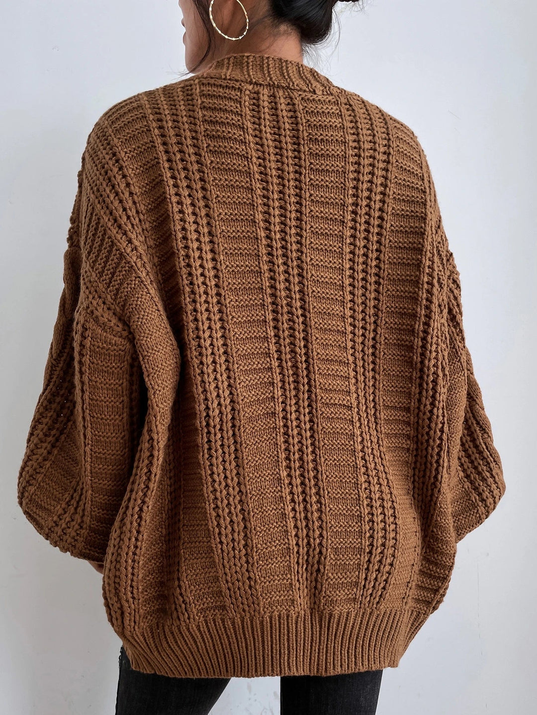 Comfortable women's oversized cable cardigan in a cozy knit. Ideal casual layering piece for fall/winter fashion.