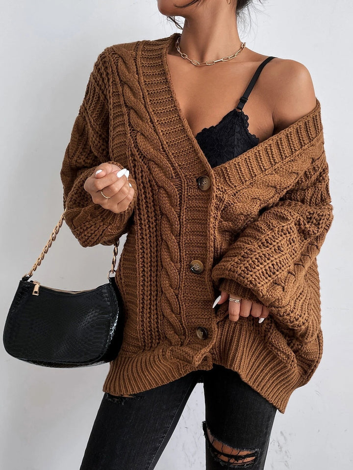 Warm women's oversized cable cardigan for autumn/winter. Cozy layering piece with a comfortable, relaxed fit style.