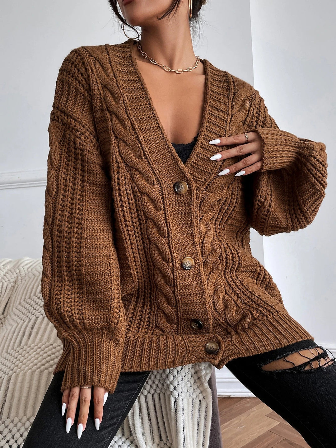 Stylish women's oversized cable cardigan. Cozy knit, relaxed fit for comfortable autumn/winter layering fashion.