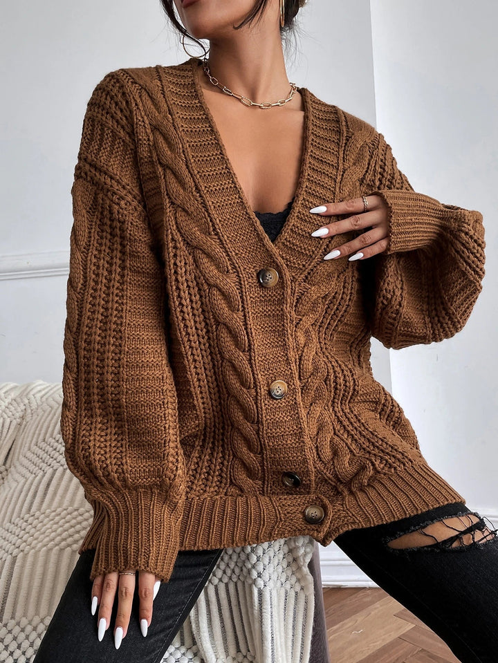 Stylish women's oversized cable cardigan. Cozy knit, relaxed fit for comfortable autumn/winter layering fashion.