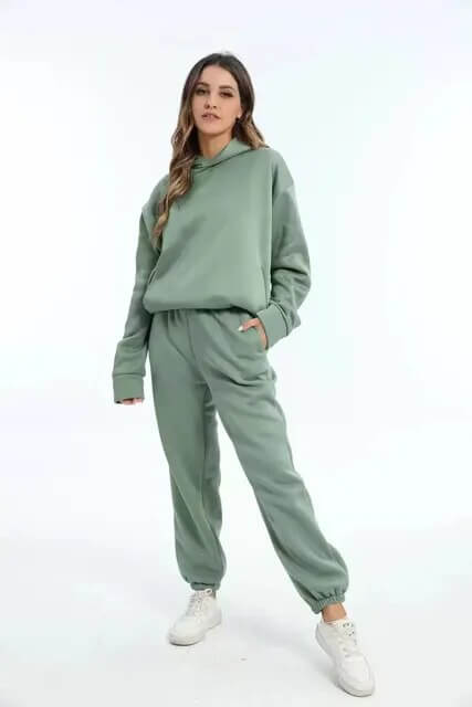 Women's cozy oversized sweat suit, featuring a comfortable hoodie & jogger pants for ultimate loungewear.