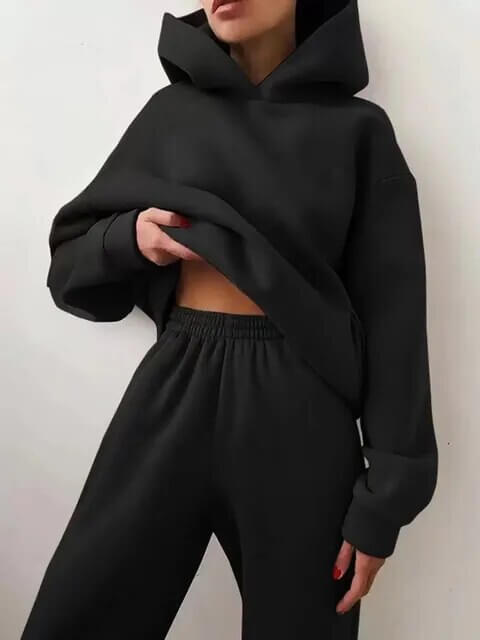 Relaxed fit women's oversized tracksuit set with a stylish hoodie & comfortable sweatpants silhouette.