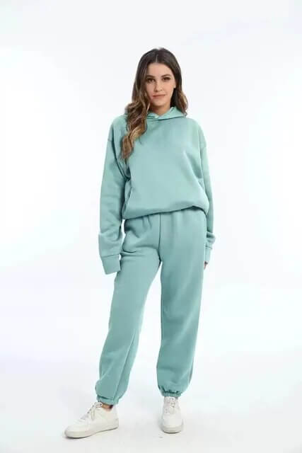 Comfortable women's oversized loungewear tracksuit. Soft hoodie and jogger pants for a cozy two-piece set.