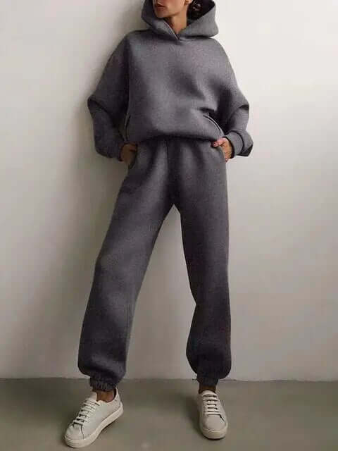 Women's oversized hoodie and matching jogger pants. Cozy two-piece sweat suit for relaxing or activewear.