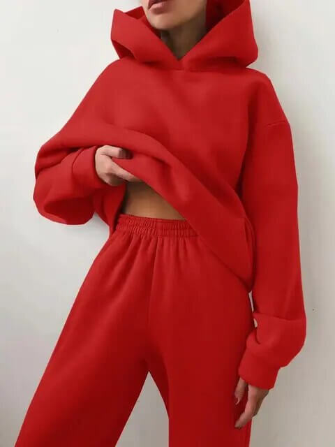 Close-up of soft fabric on a women's oversized tracksuit. Cozy hoodie & sweatpants, ideal for comfort.