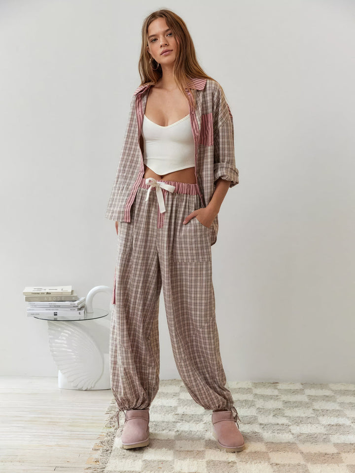 Front view of a women's cozy red and black plaid flannel pajama top for winter comfort.