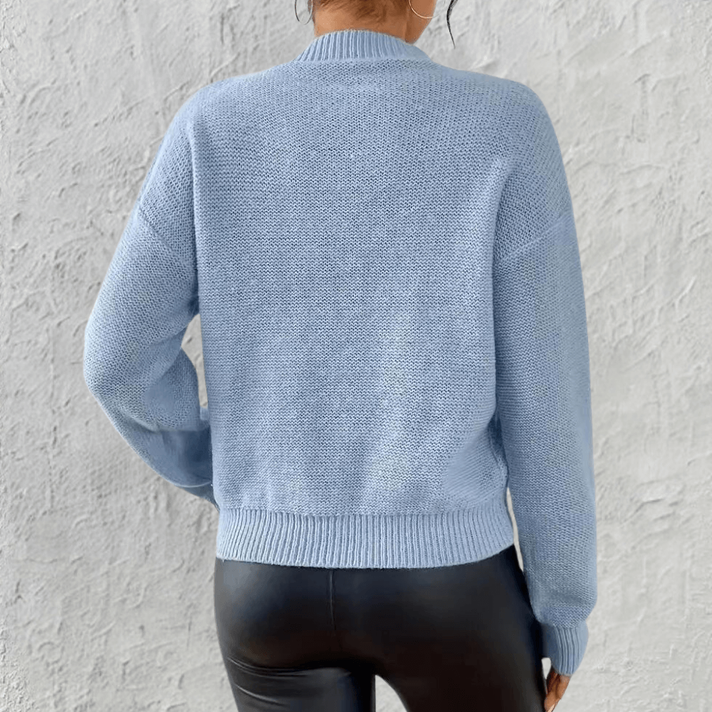 Comfortable long sleeve blue knit sweater for women, featuring a cozy relaxed fit; ideal for fall/winter fashion.