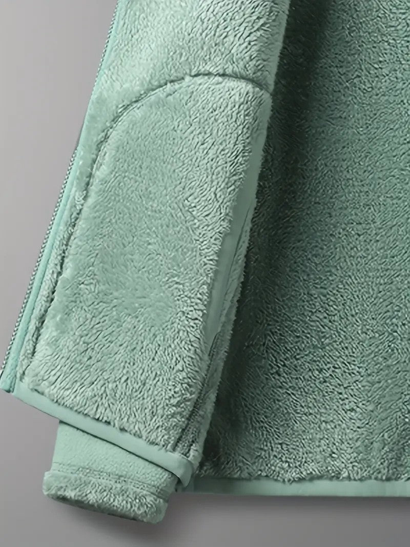 Snug stand collar detail on a women's reversible winter jacket, providing extra neck warmth and style.