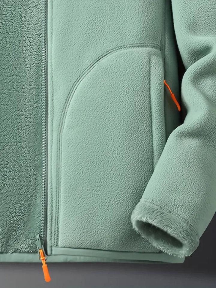Women's reversible winter jacket laid flat, showing cozy texture & zip-up stand collar design.