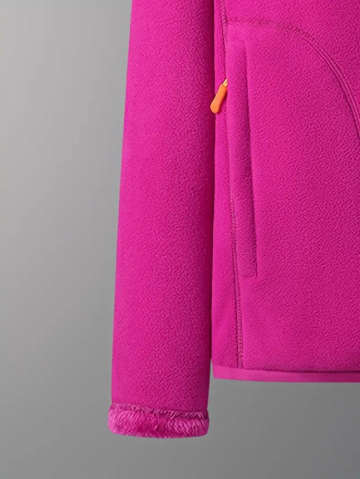 Close-up of cozy, fluffy texture on a women's reversible winter jacket, hanging for display.