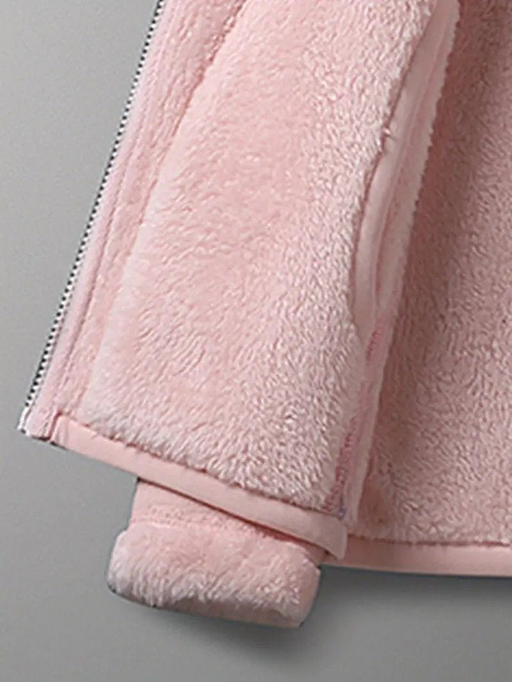 Full zip-up detail of a women's warm winter jacket, reversible & perfect for casual daily wear.