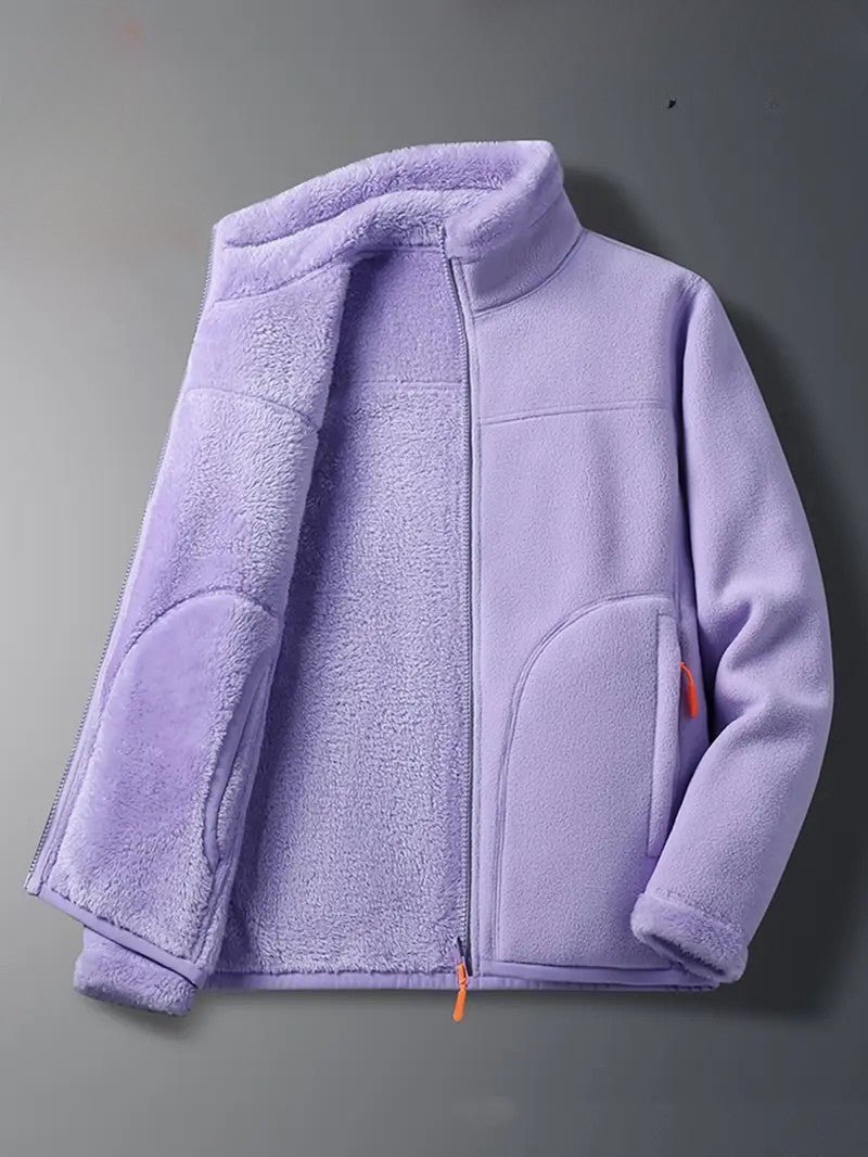 Woman wearing a cozy reversible zip-up winter jacket with stand collar for casual fall fashion.
