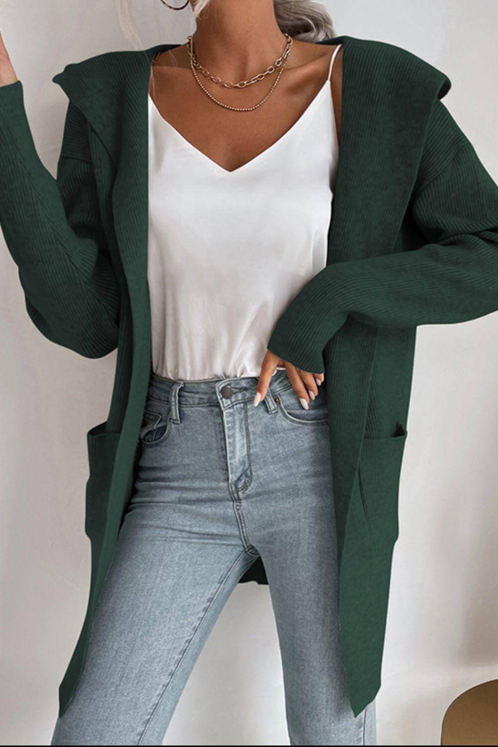 Cozy women's ribbed hooded cardigan sweater with practical pockets, ideal for comfortable daily wear.