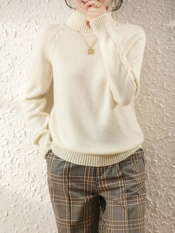 Women's warm long sleeve roll neck jumper. Cozy knitted top for winter fashion.