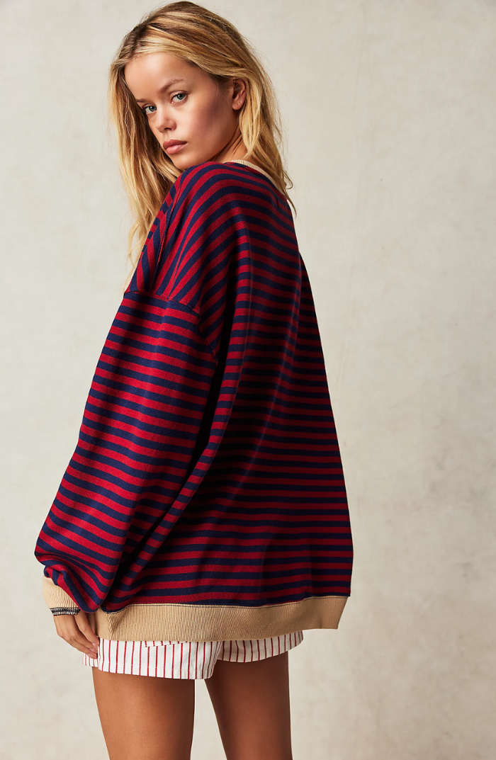 Detail shot of the striped pattern on a women's cozy crewneck sweater, showcasing the soft knit texture.