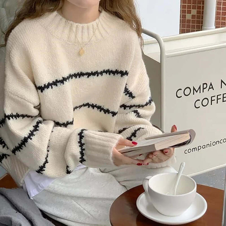 Fashionable ladies long sleeve knitted top, featuring a comfy striped pattern and classic round neck.