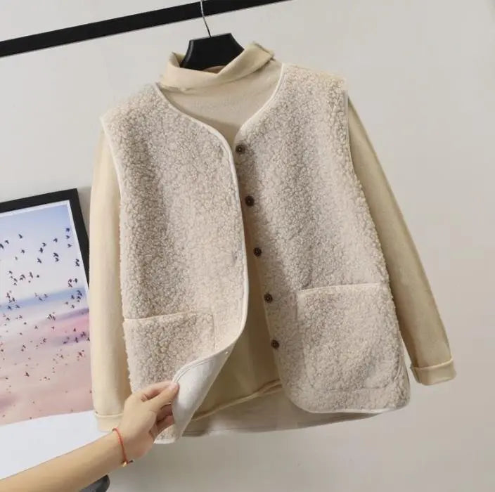 Close-up of women's textured fleece vest in khaki, showcasing soft fabric & stylish design for fall fashion.