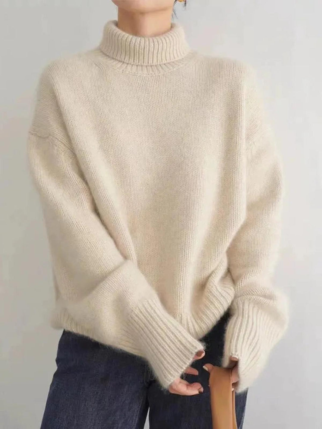 Effortless style with a women's long sleeve turtleneck sweater, ideal for chilly fall and winter days.