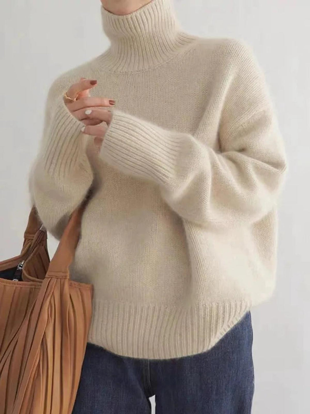 Warm beige women's cozy turtleneck sweater, a comfortable long sleeve pullover for everyday winter wear.