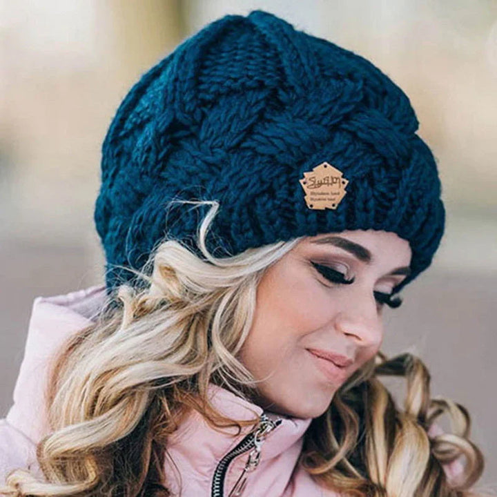 Warm knitted beanie for women, an essential outdoor gear accessory for cold weather and winter activities.