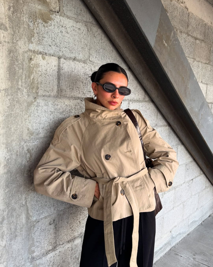 Elegant women's fall cropped trench coat, classic double-breasted design with belt.