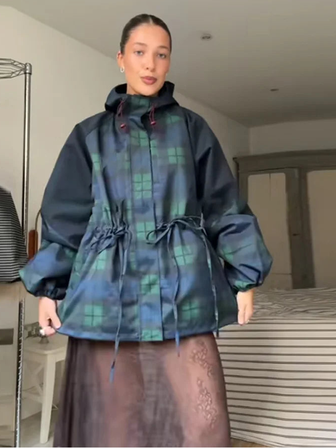 Relaxed fit women's oversized plaid jacket in dark blue. Hooded & adjustable waist design for modern utility outerwear.