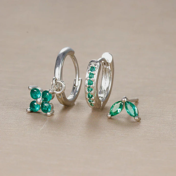 Elegant women's ear piercing set featuring surgical steel studs, hoops, and sparkling cubic zirconia jewelry.