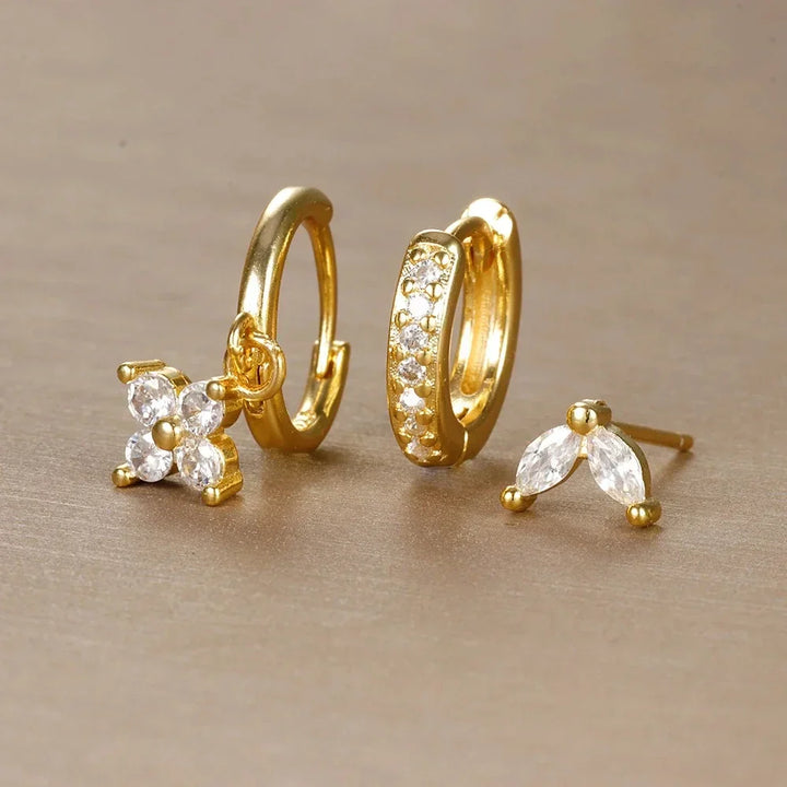Modern women's ear piercing set, hypoallergenic surgical steel hoops & studs with cubic zirconia for daily wear.