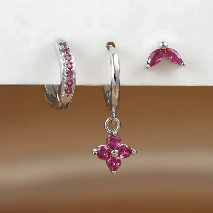 Collection of women's ear piercings: surgical steel studs, hoops, and CZ earrings, ideal for multiple piercings.