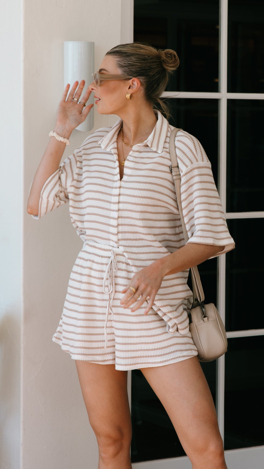 Stylish women's matching striped top and shorts set, perfect for beachwear, vacation, and sunny day fashion.
