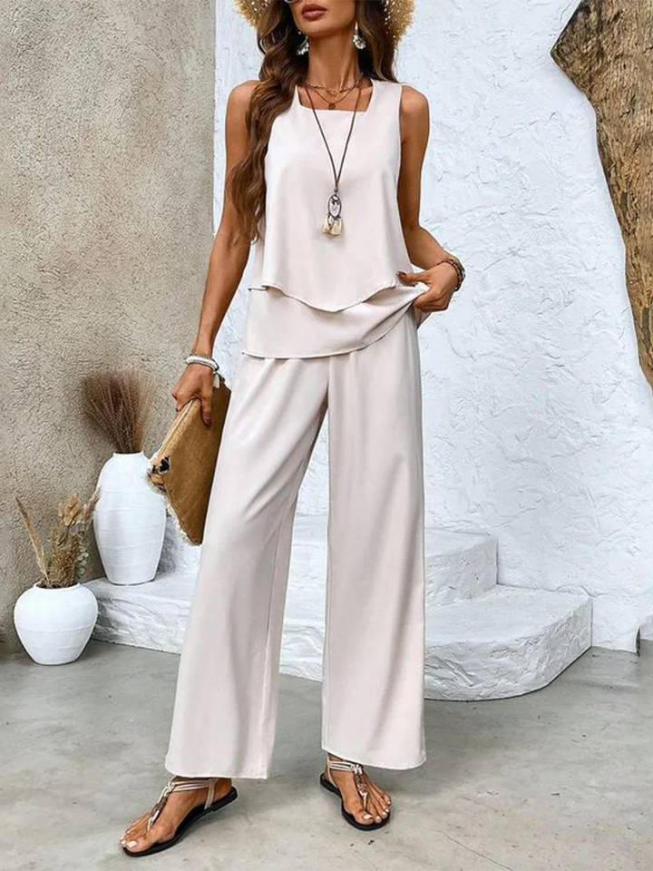Women's vacation style two-piece summer set with wide-leg pants & a flattering layered top.