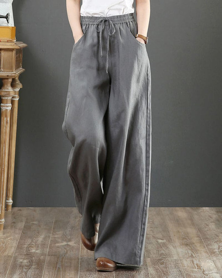 Chic women's wide leg flowy trousers with elastic drawstring waist. Perfect for casual spring & summer fashion.