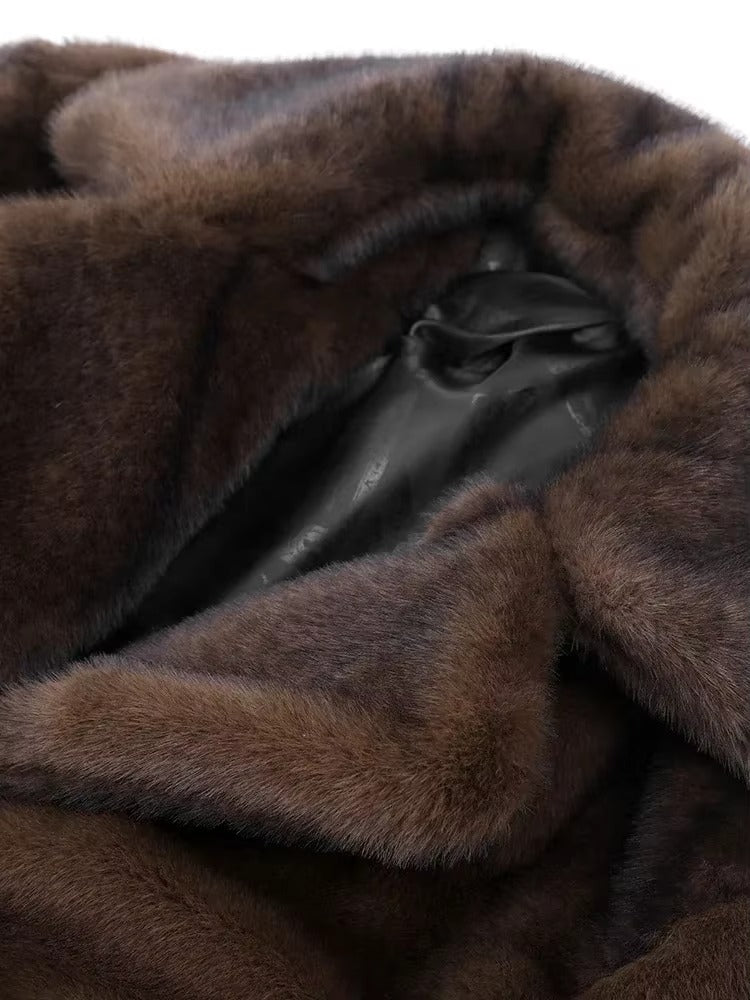 Warm women's long dark brown winter coat, elegant oversized outerwear perfect for cold season fashion.